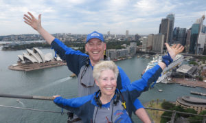 Rick and Molly Klau pose for a photo on a bridge overlooking Sydney Australia