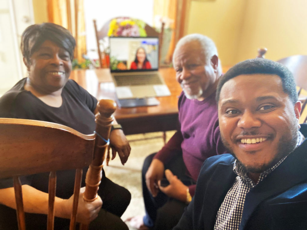 Raymael Blackwell (right), a Program Officer at Community First Foundation, watches the Denver Business Journal's 40 Under 40 awards on-line presentation with his parents in Pueblo, Colo. on May 6, 2021.